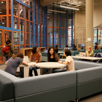 Students sitting in a common area at a table talking